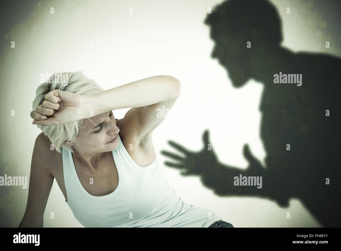 Composite image of depressed woman on the floor Stock Photo