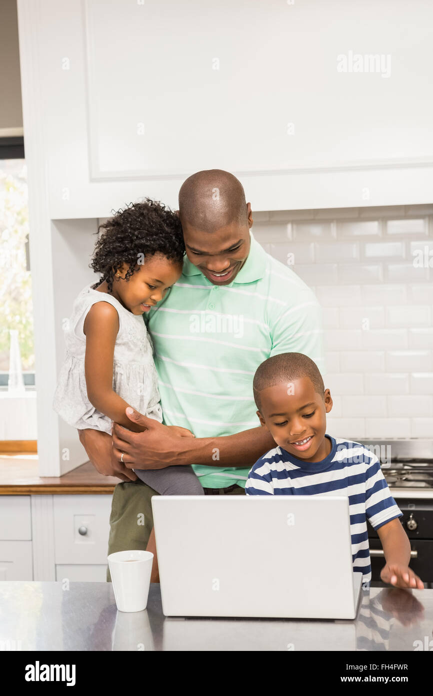 Happy family using laptop Stock Photo - Alamy