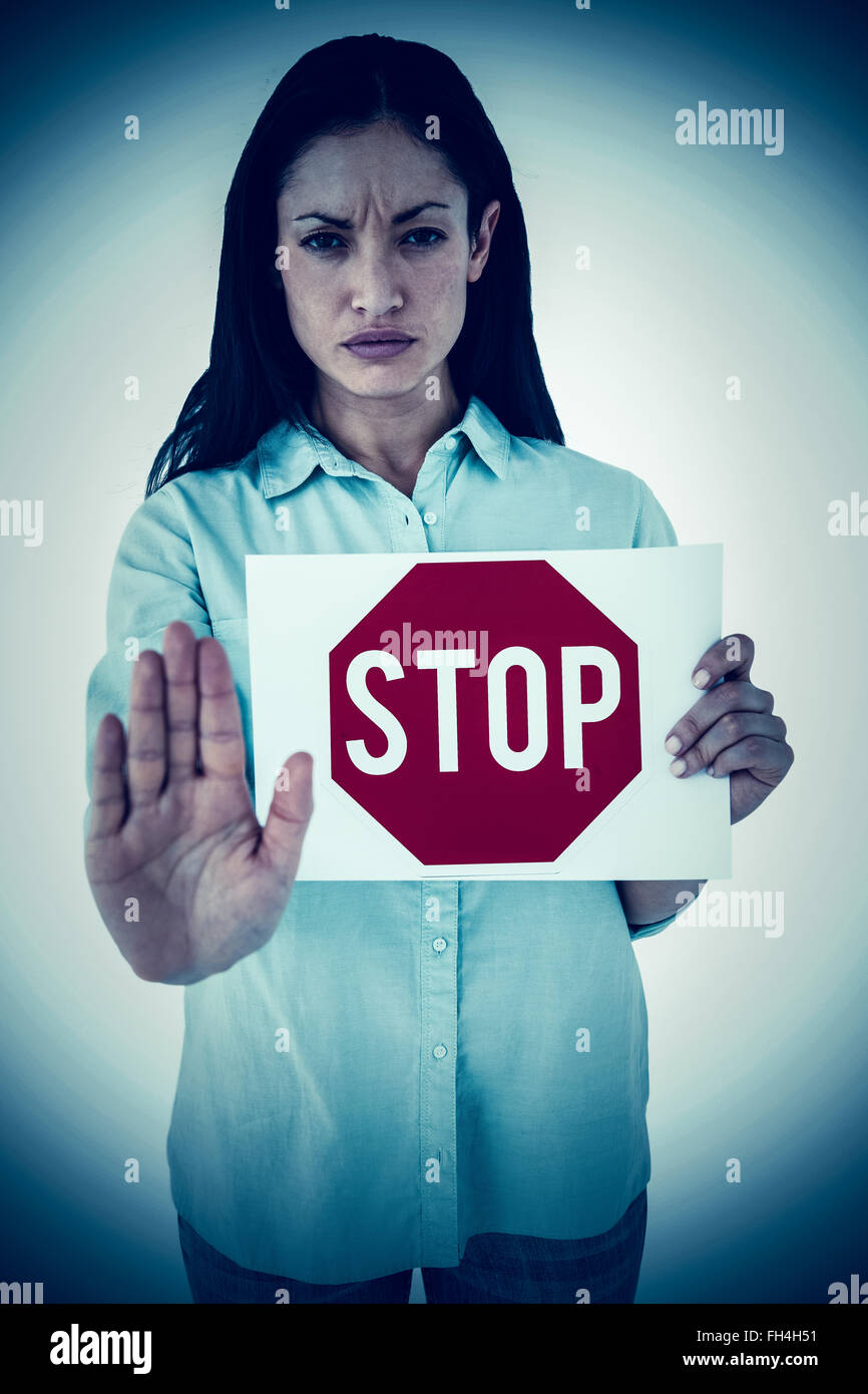 Composite image of woman showing card and saying stop Stock Photo - Alamy