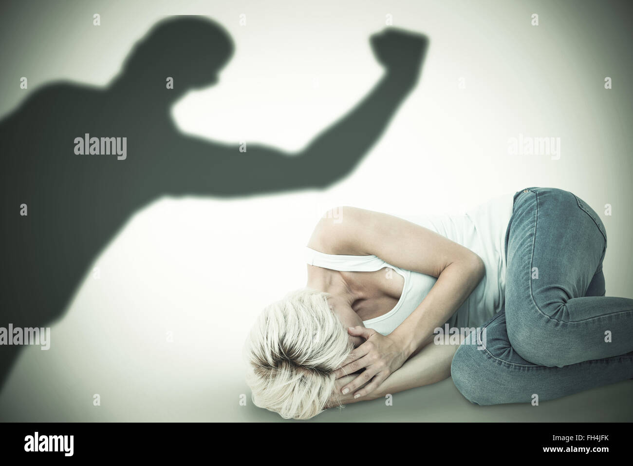 Composite image of sad blonde woman lying on the floor Stock Photo