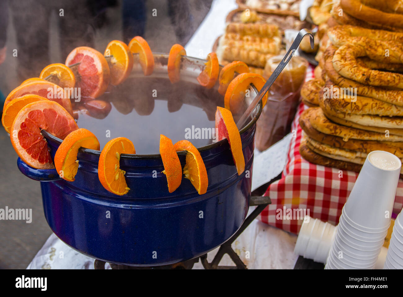 https://c8.alamy.com/comp/FH4ME1/a-large-container-of-mulled-wine-being-kept-warm-beside-some-plastic-FH4ME1.jpg