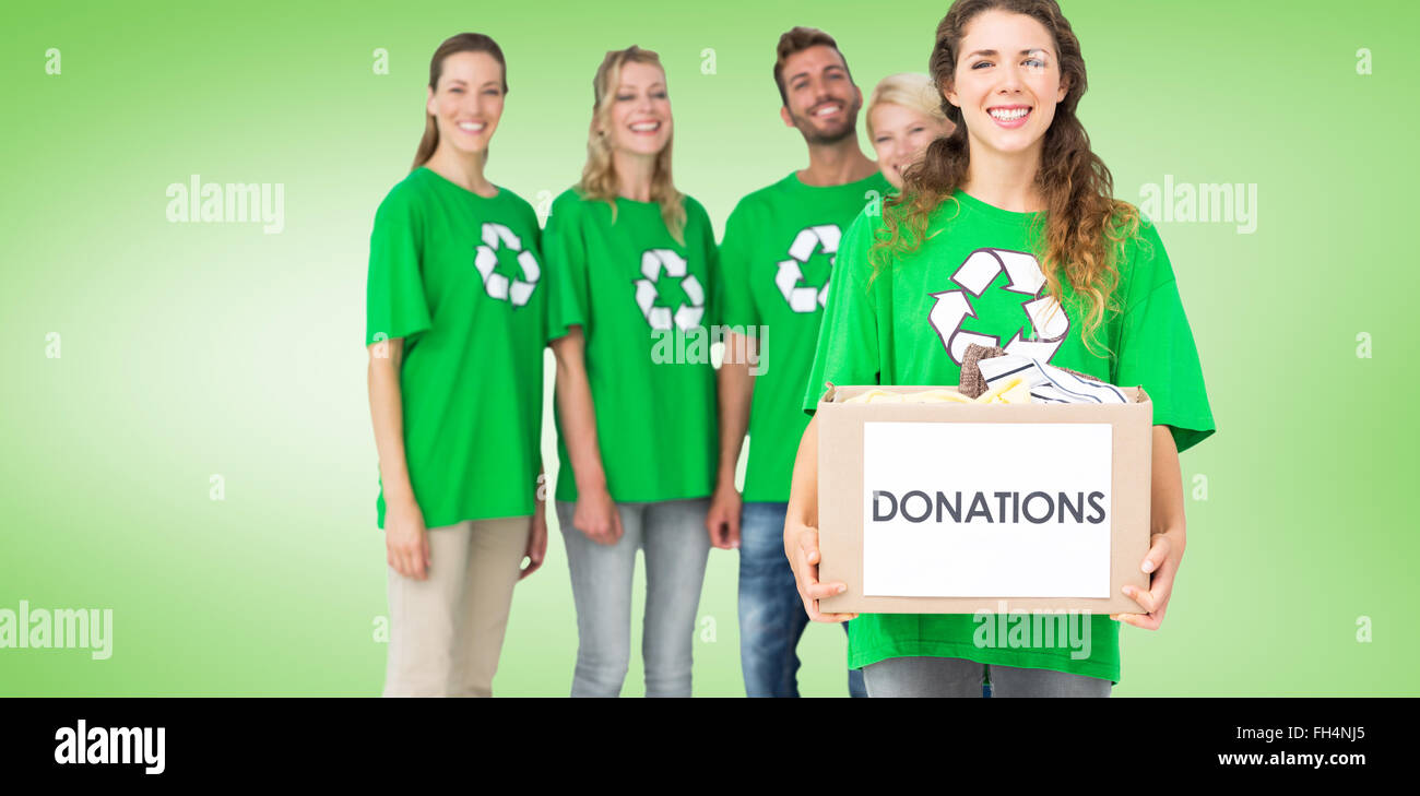 Composite image of people in recycling symbol tshirts with donation box Stock Photo