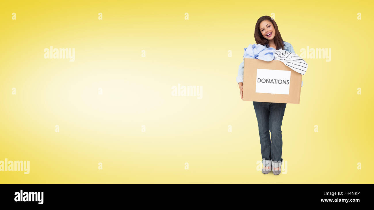 Composite image of portrait of a young woman with clothes donation Stock Photo