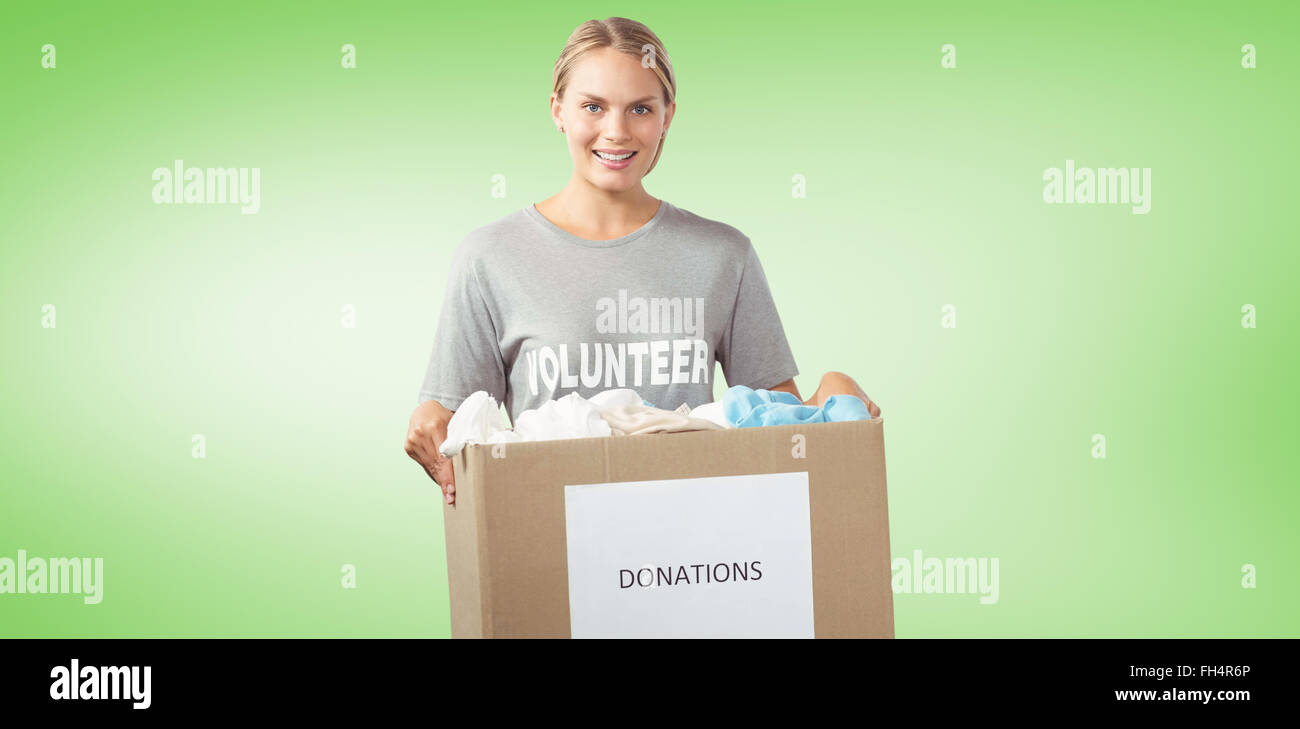 Composite image of portrait of beautiful woman holding clothes donation box Stock Photo