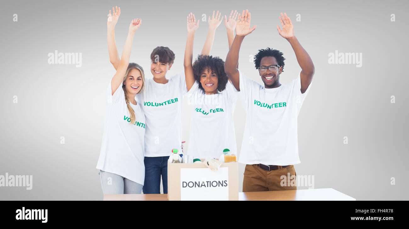 Composite image of volunteers raising their arms Stock Photo