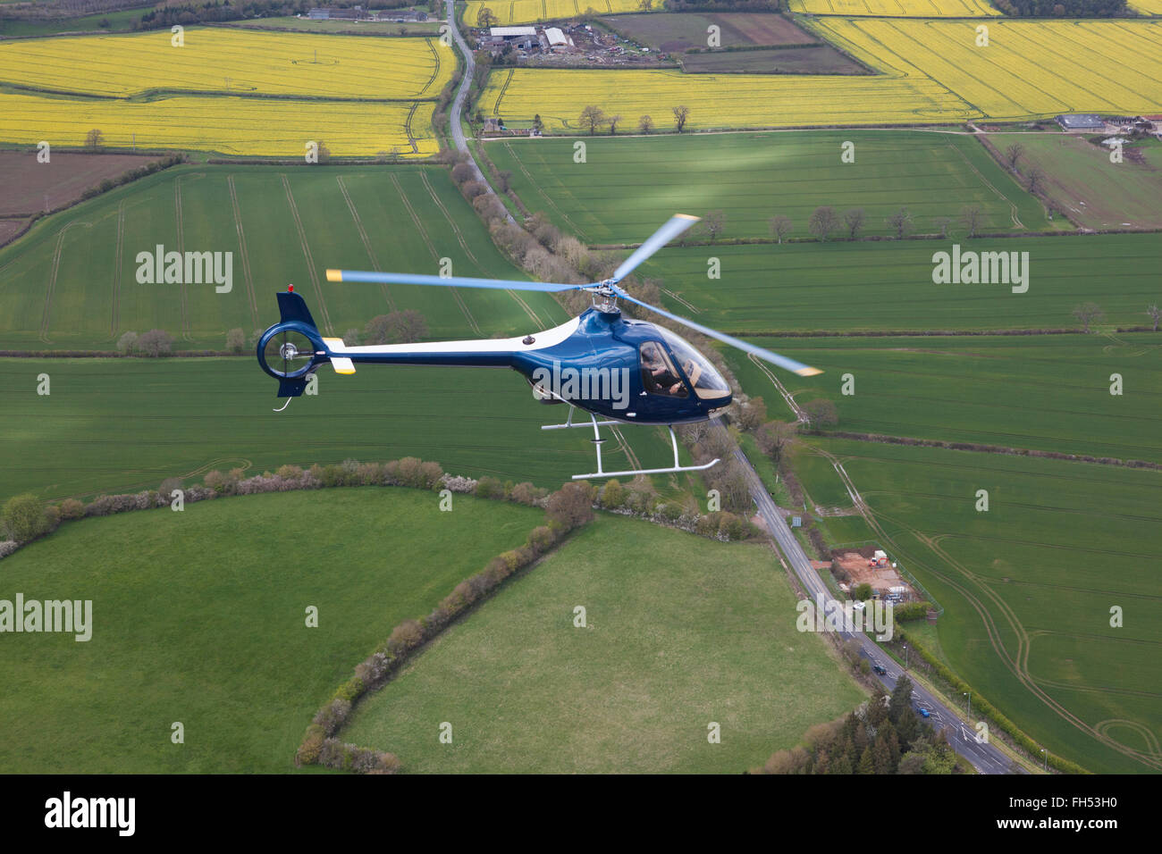A Cabri G2 helicopter made by Guimbal flying over the cotswold