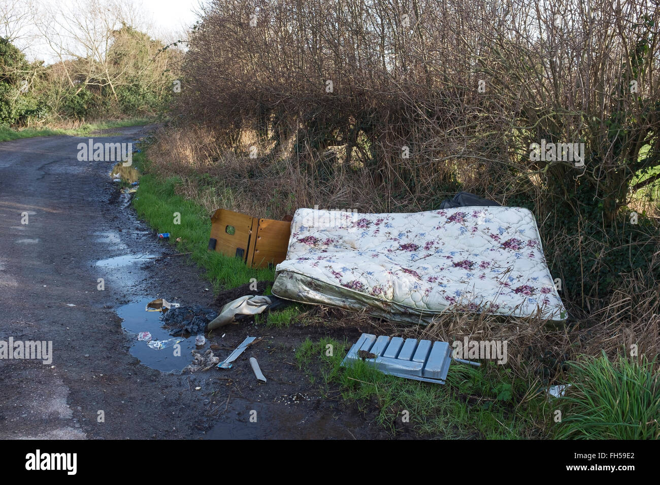 Fly tipping mattress dumped in the countryside Stock Photo