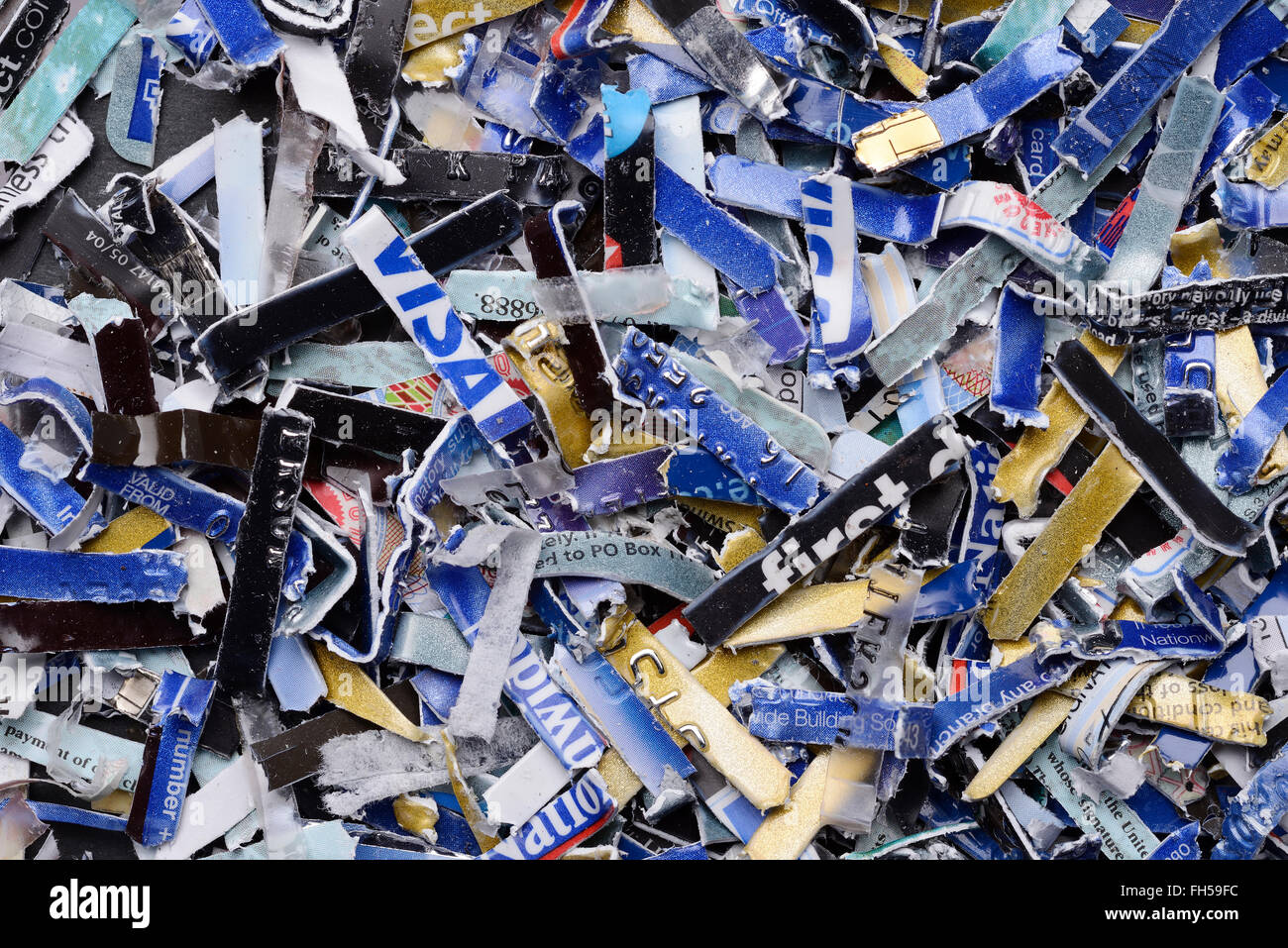 Bank credit cards and debit cards that have been security shredded Stock Photo