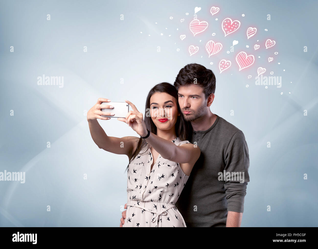Couple in love taking selfie with red heart Stock Photo - Alamy