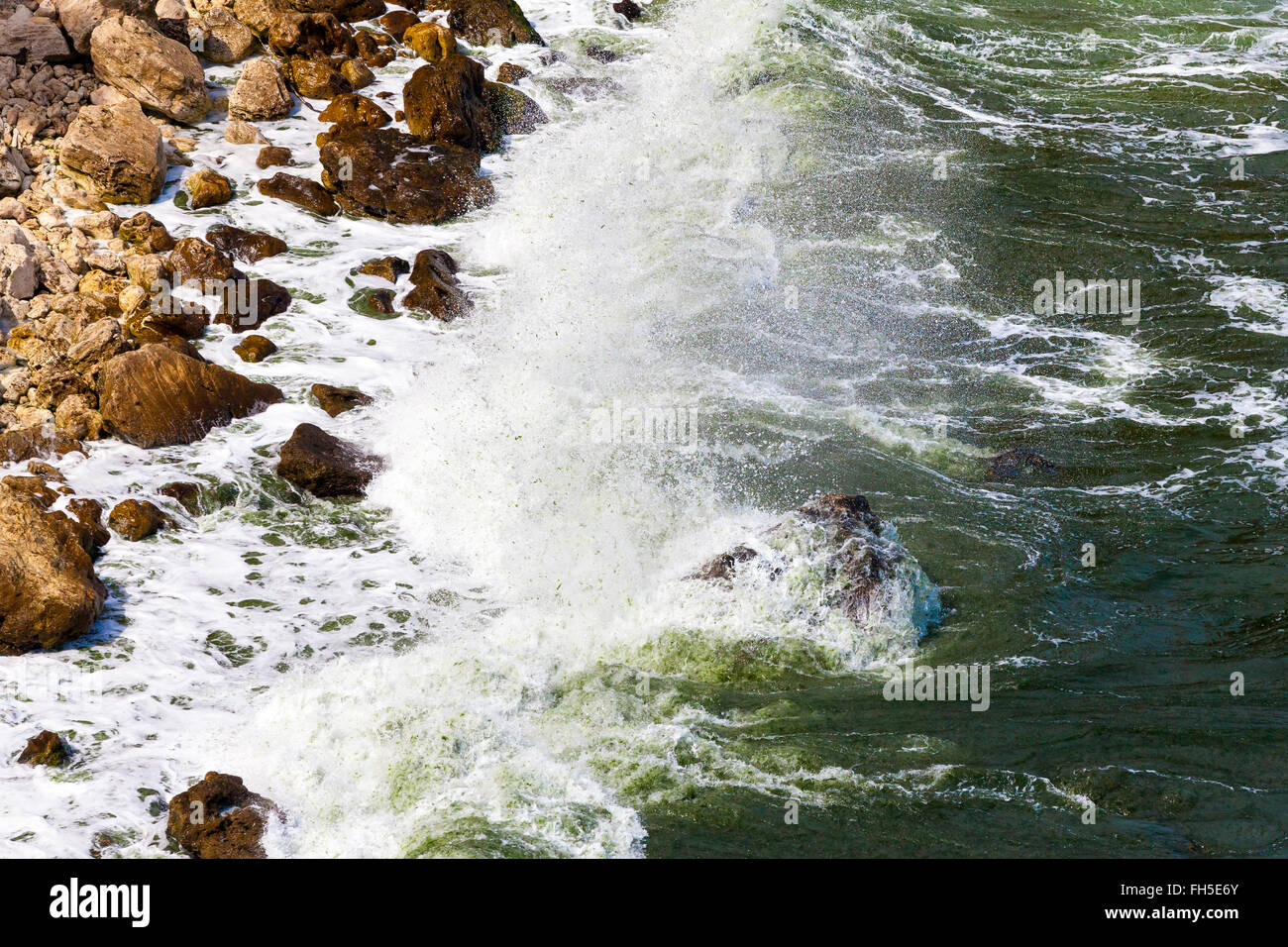 Rock and waves Stock Photo - Alamy