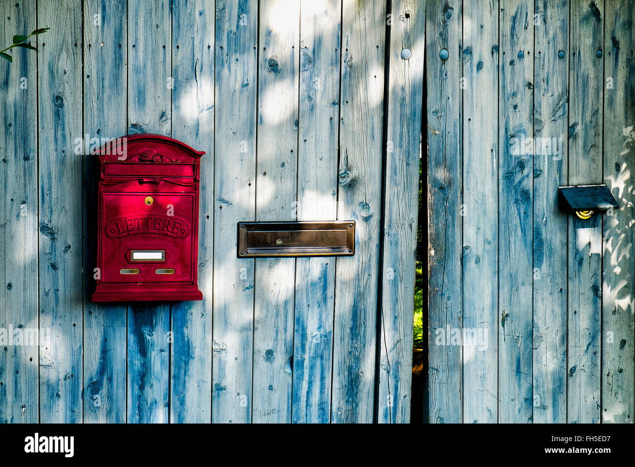 Wooden door and gate with red letterbox, Germany Stock Photo - Alamy