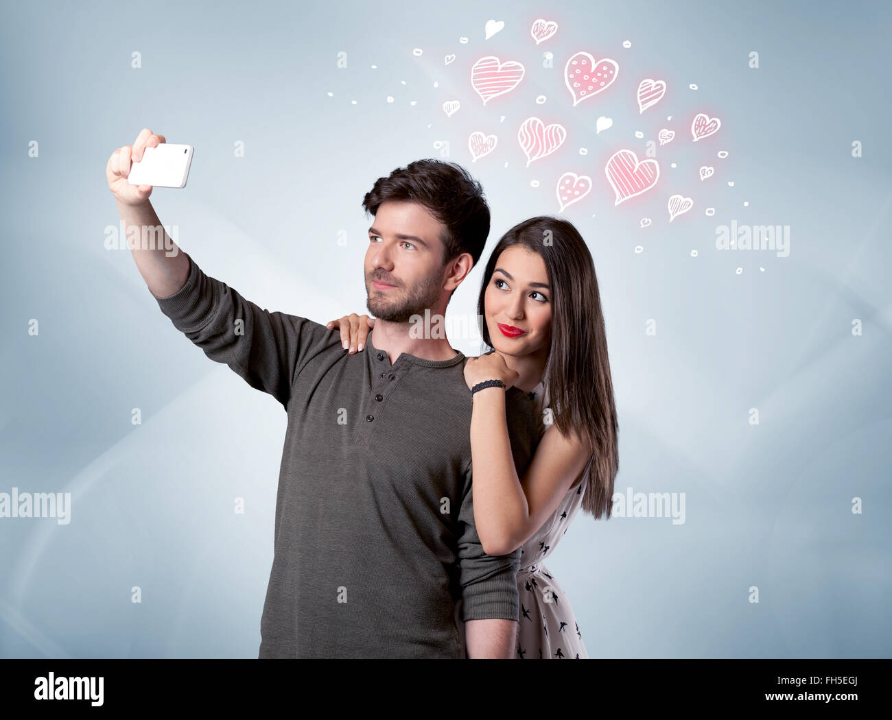 Couple in love taking selfie with red heart Stock Photo - Alamy