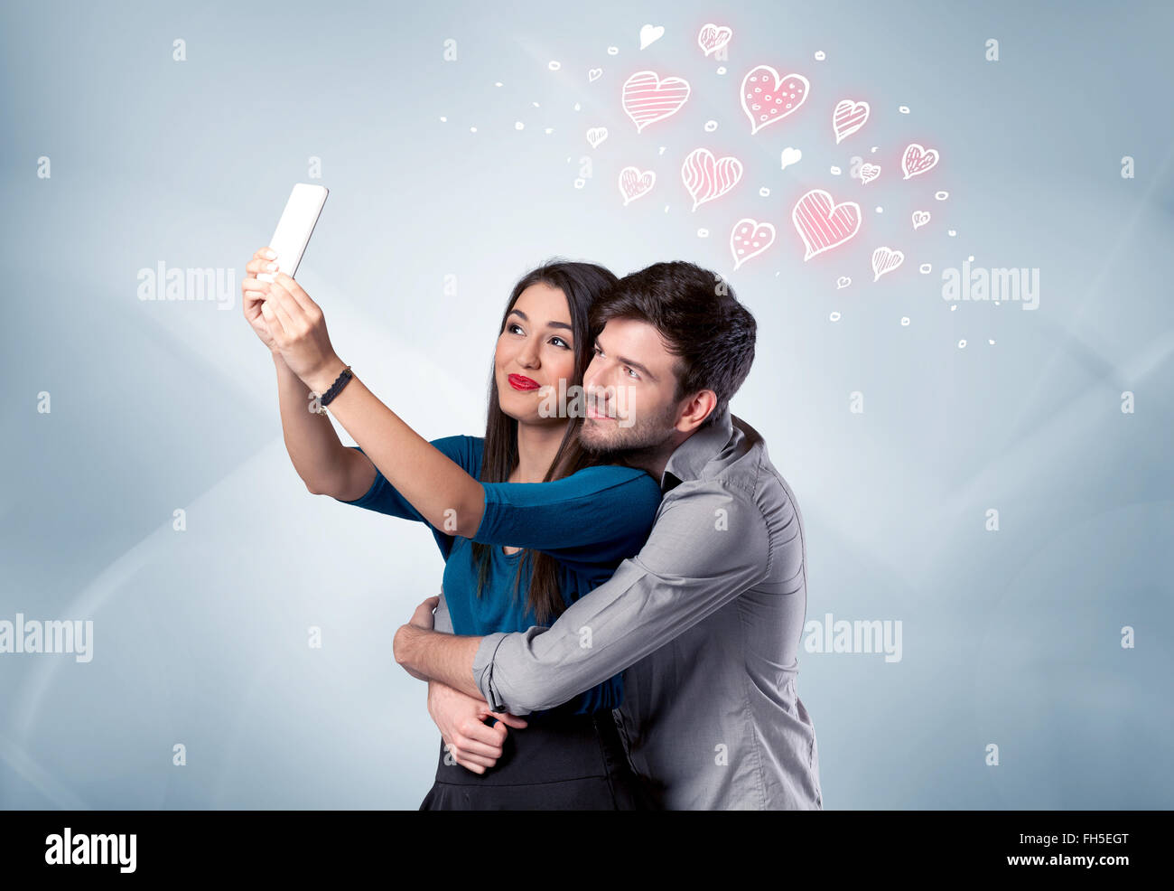 Couple in love taking selfie with red heart Stock Photo - Alamy