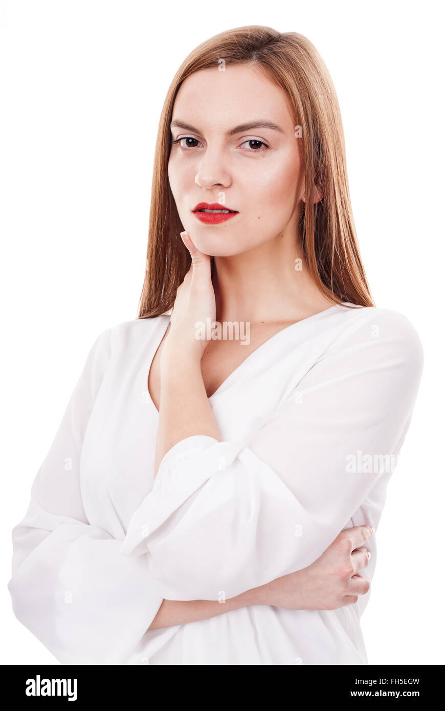 Serious young woman posing relaxed on white background Stock Photo