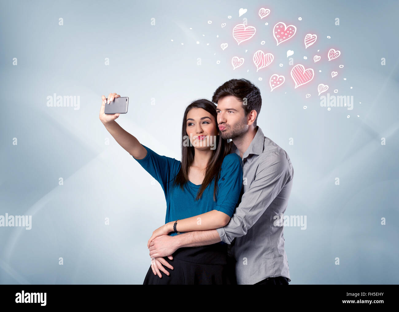 Couple in love taking selfie with red heart Stock Photo - Alamy