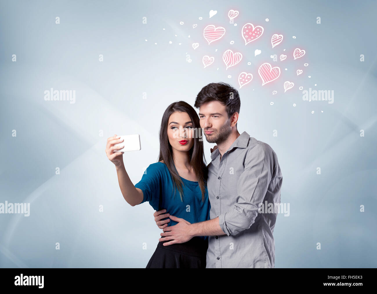 Couple in love taking selfie with red heart Stock Photo - Alamy