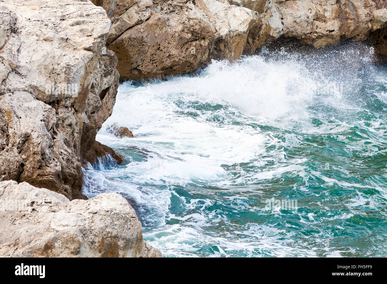 Rock and waves Stock Photo - Alamy