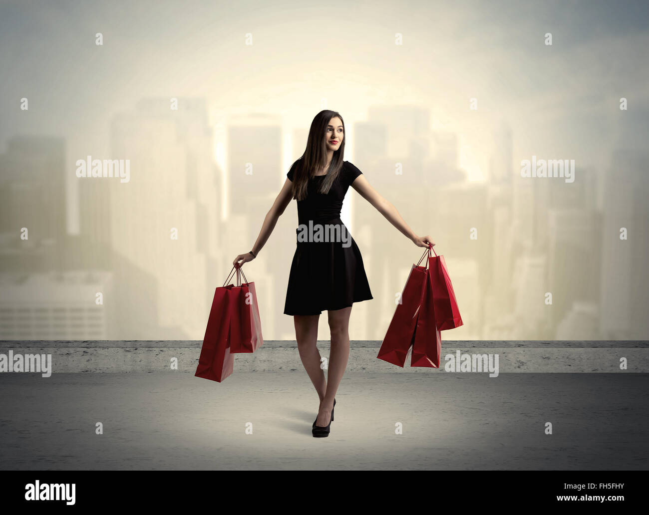 City woman standing with shopping bags Stock Photo - Alamy