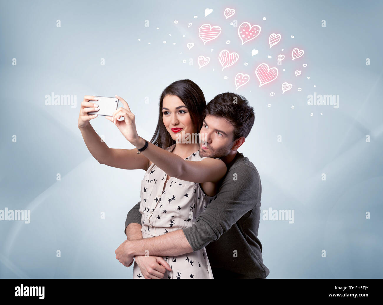 Couple in love taking selfie with red heart Stock Photo - Alamy