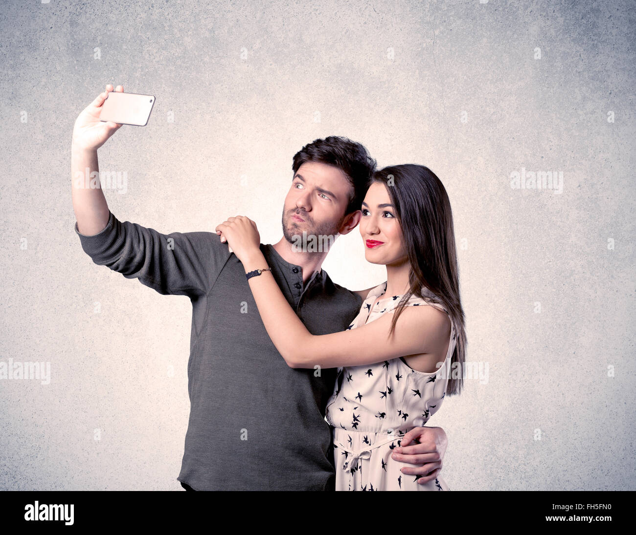 Happy couple taking selfie with clear wall Stock Photo - Alamy