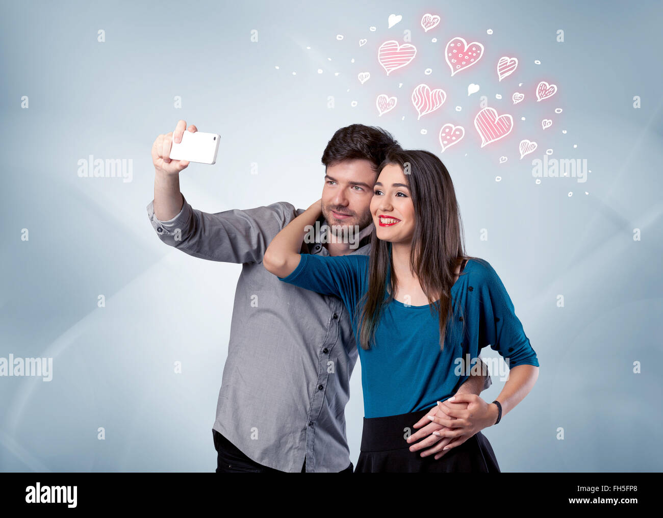 Couple in love taking selfie with red heart Stock Photo - Alamy
