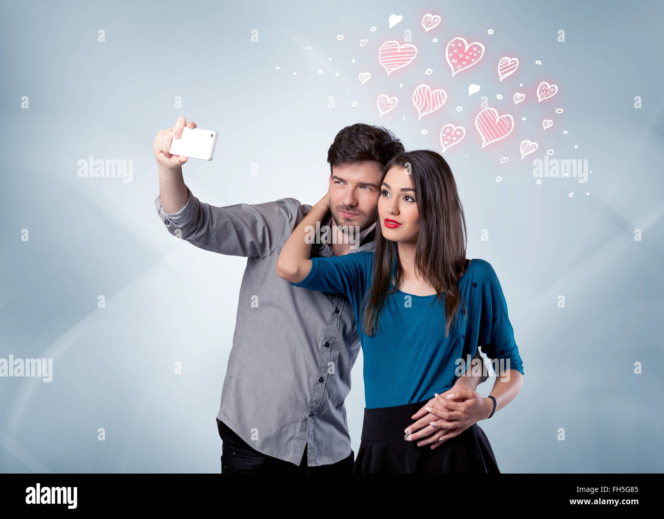 Couple in love taking selfie with red heart Stock Photo - Alamy