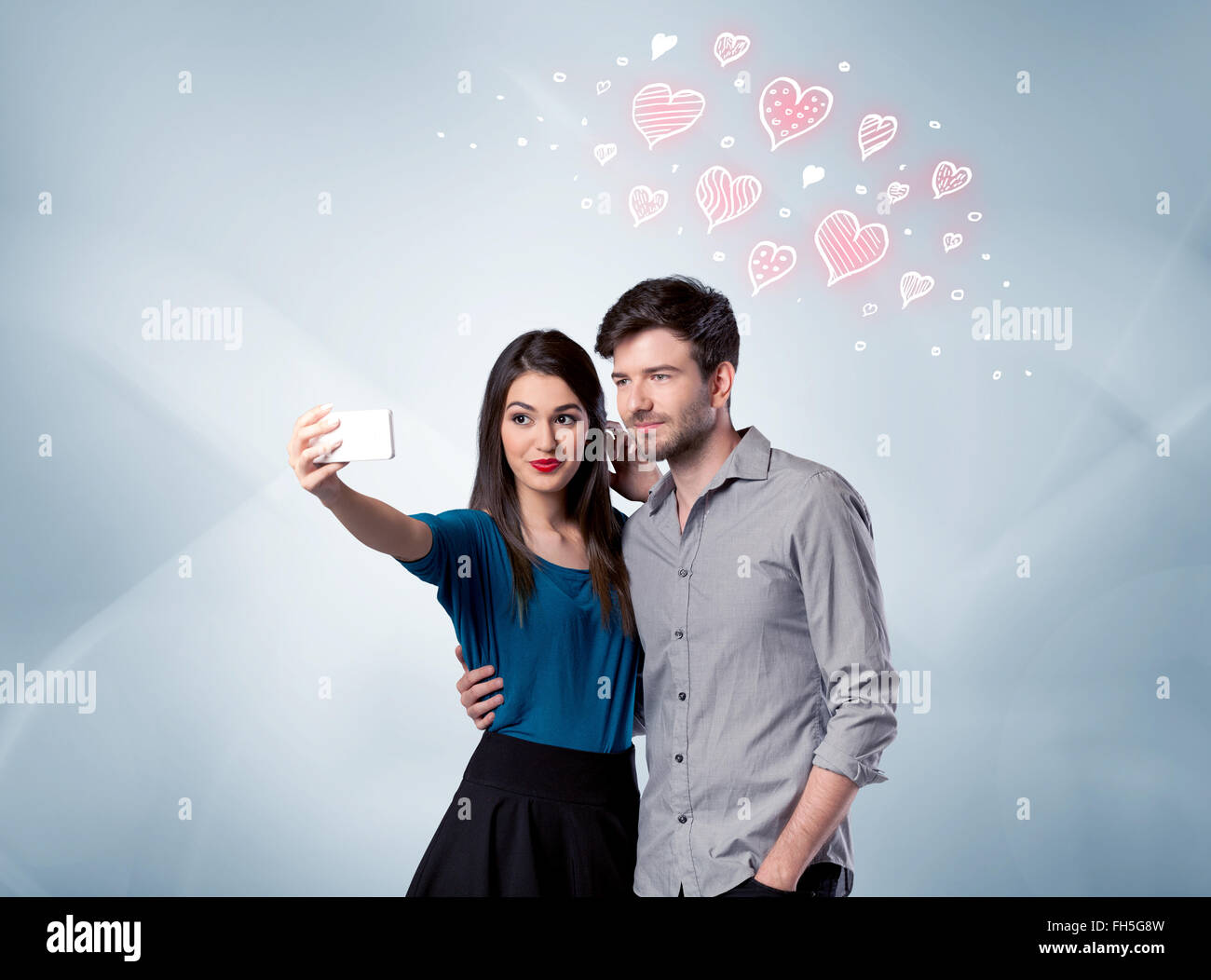 Couple in love taking selfie with red heart Stock Photo - Alamy