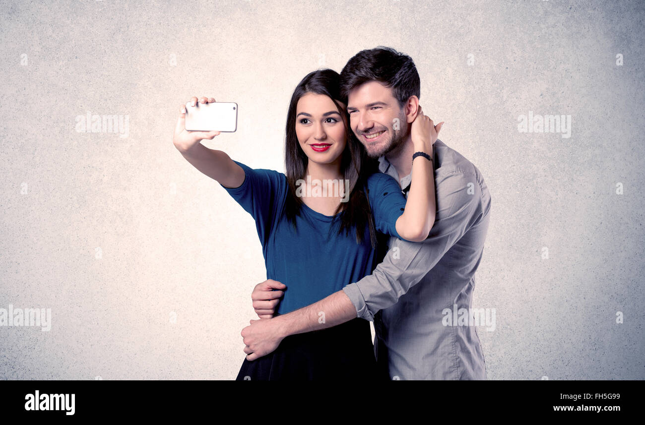 Happy couple taking selfie with clear wall Stock Photo - Alamy