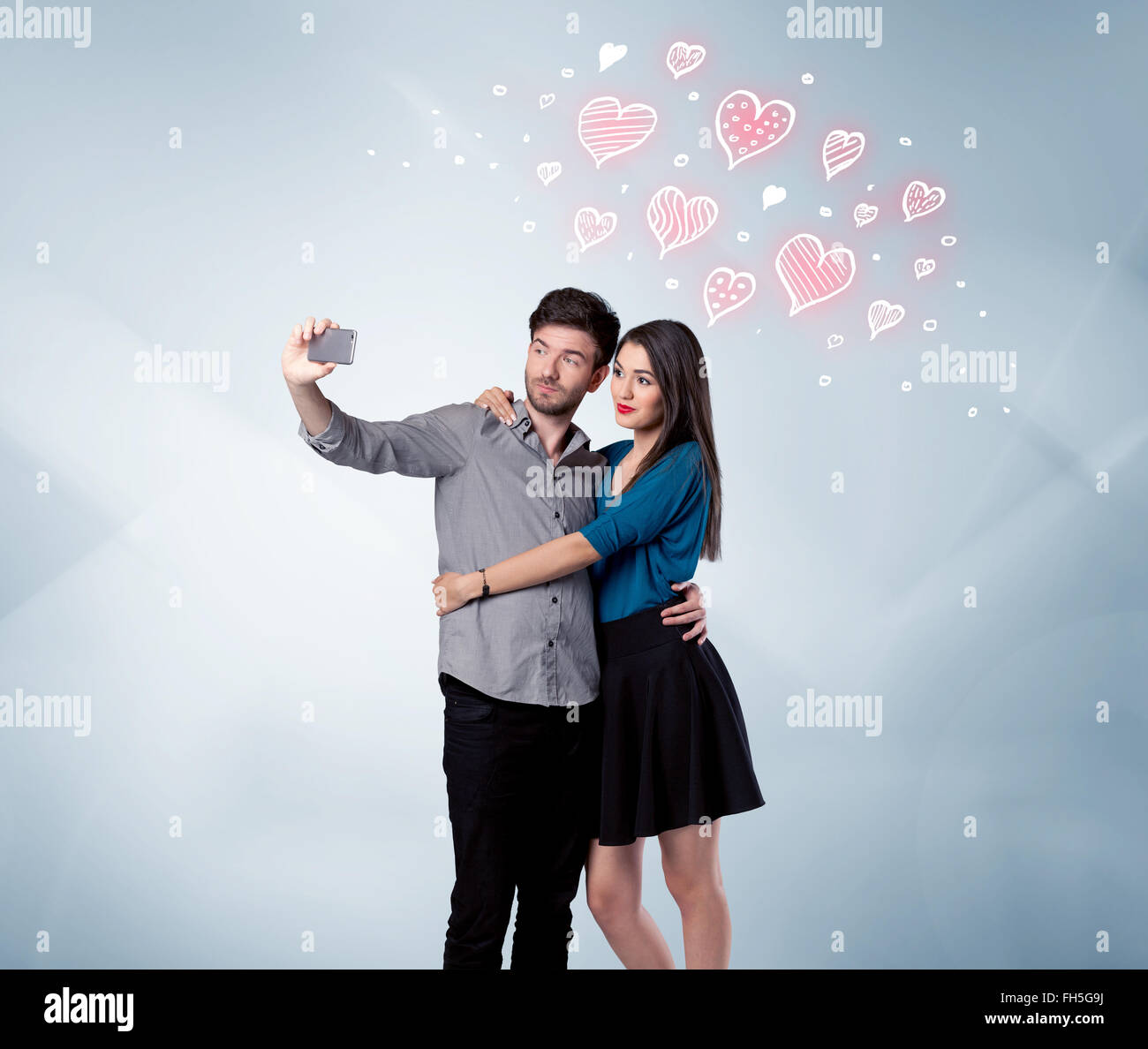 Couple in love taking selfie with red heart Stock Photo - Alamy