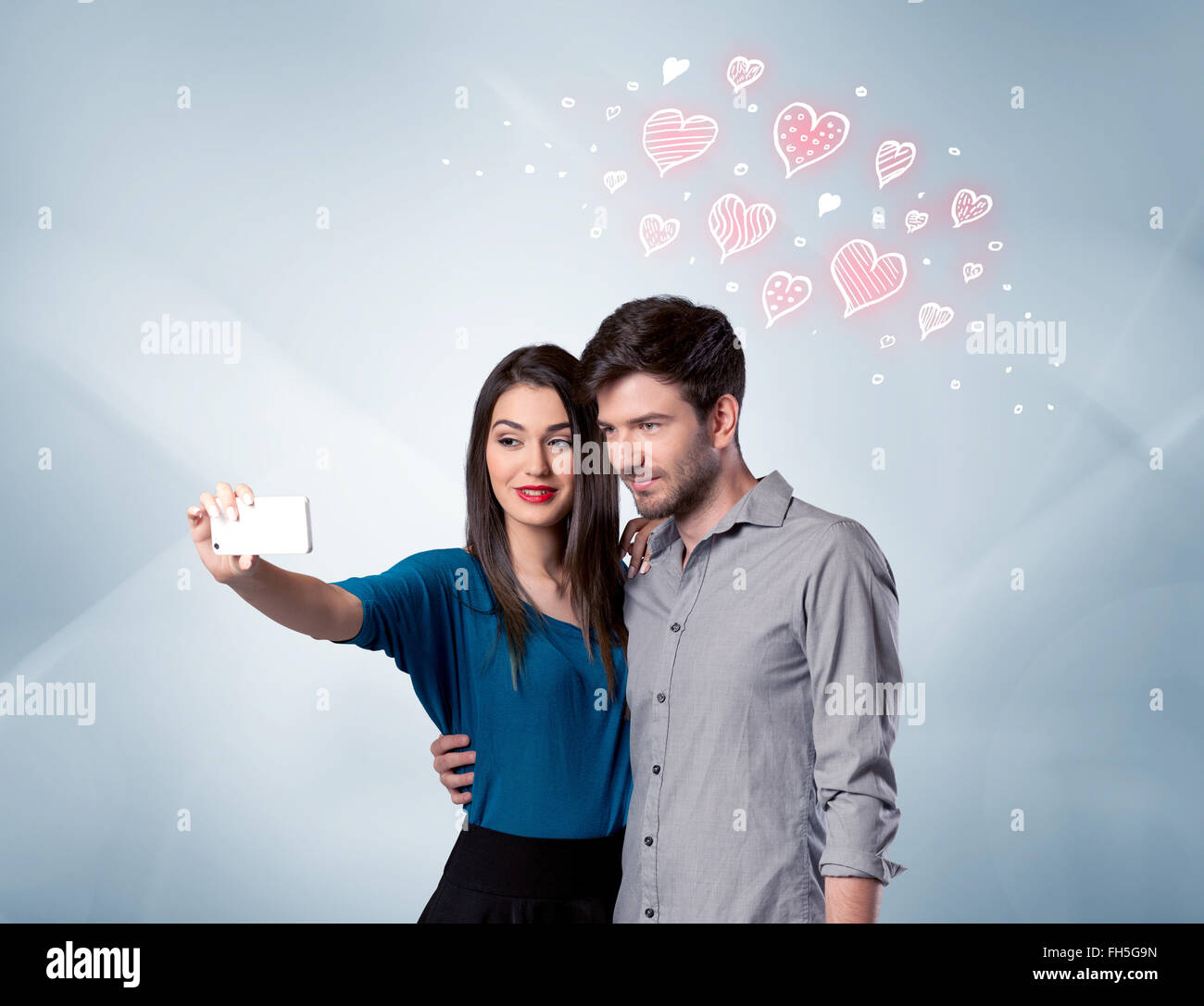 Couple in love taking selfie with red heart Stock Photo - Alamy