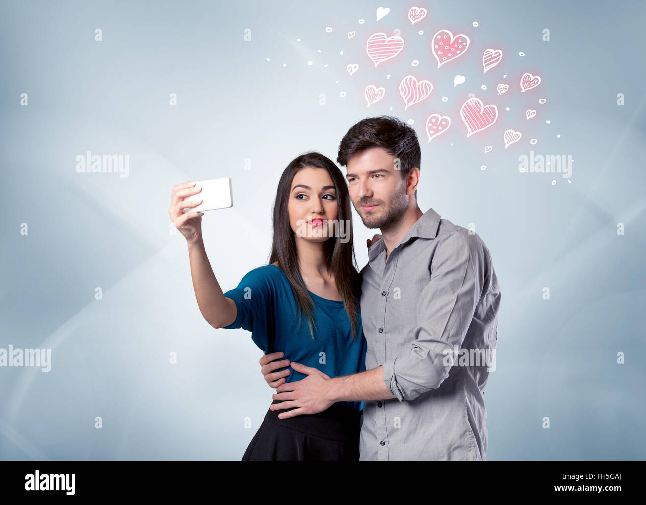 Couple in love taking selfie with red heart Stock Photo - Alamy