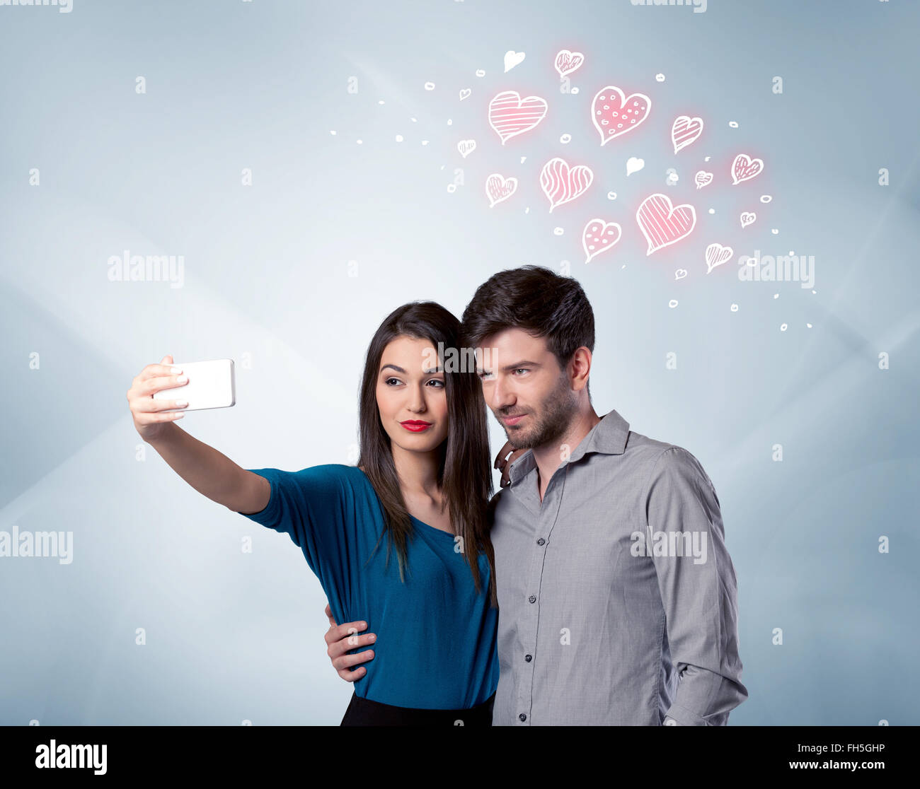 Couple in love taking selfie with red heart Stock Photo - Alamy