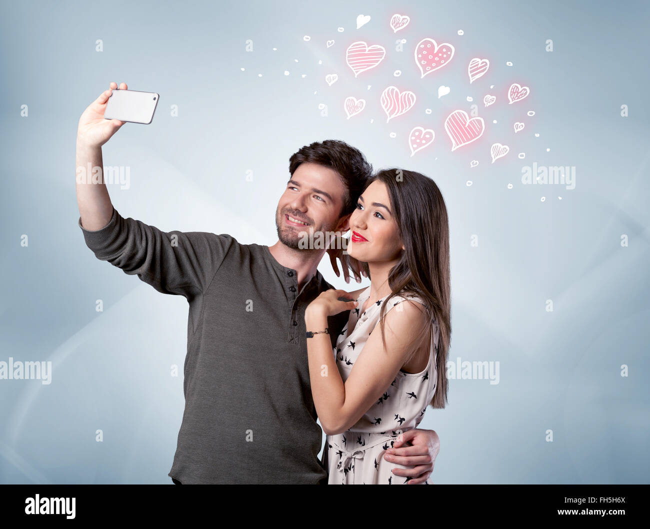 Couple in love taking selfie with red heart Stock Photo - Alamy