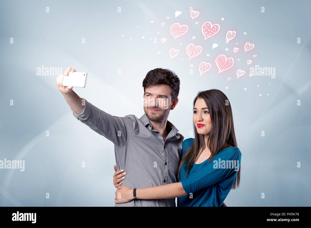 Couple in love taking selfie with red heart Stock Photo - Alamy