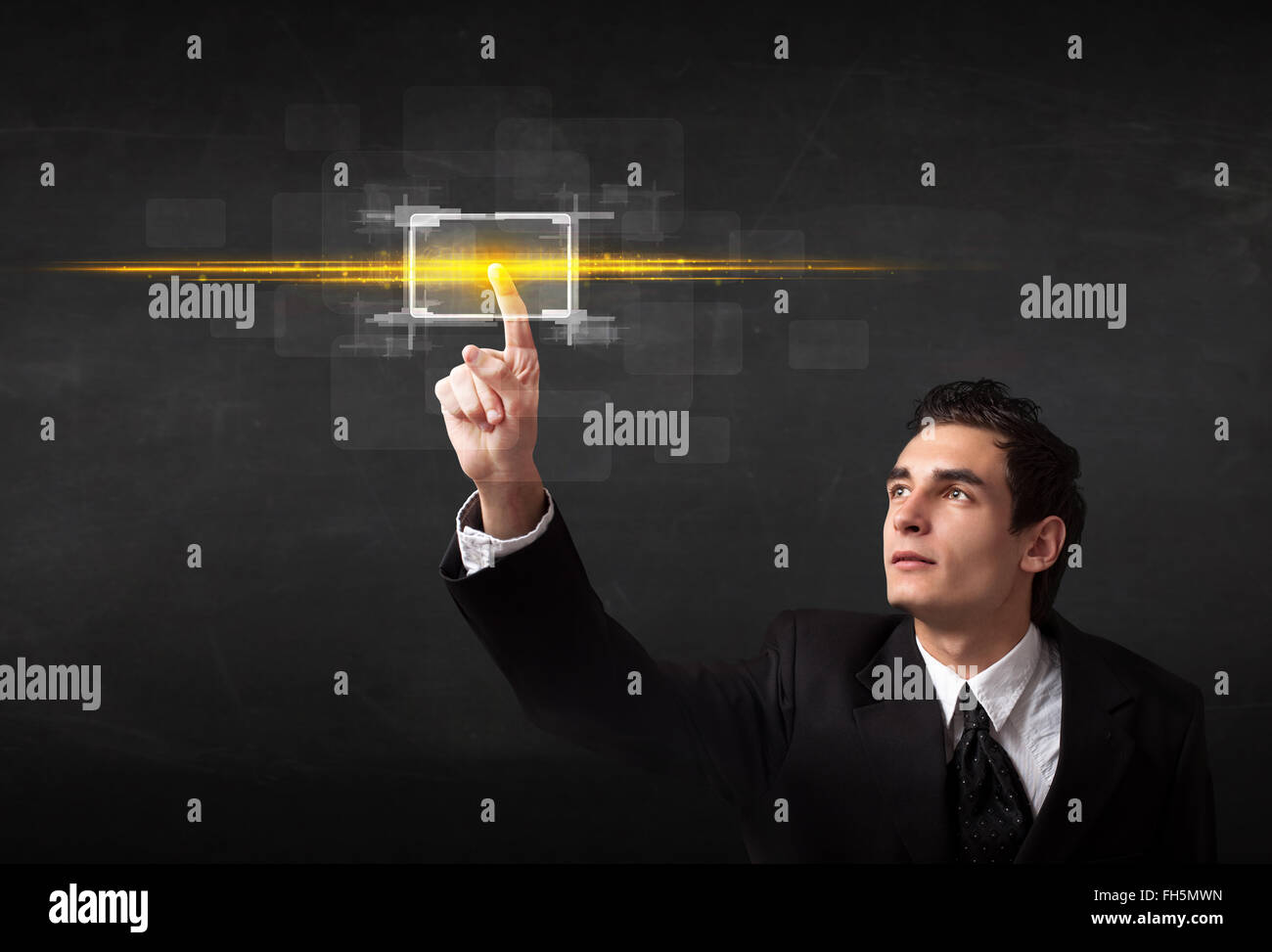 Tech business person touching button with orange light beams concept ...