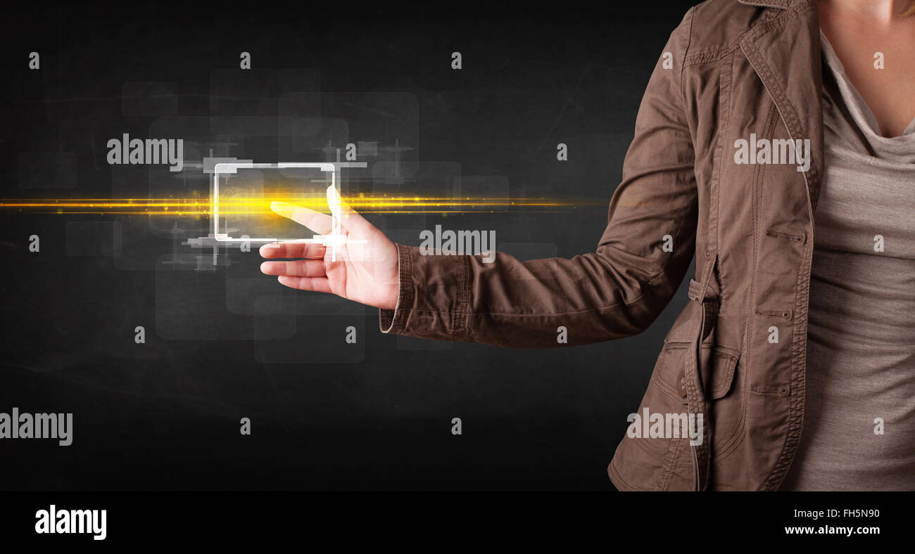 Young tech lady touching button with orange light beams concept Stock ...