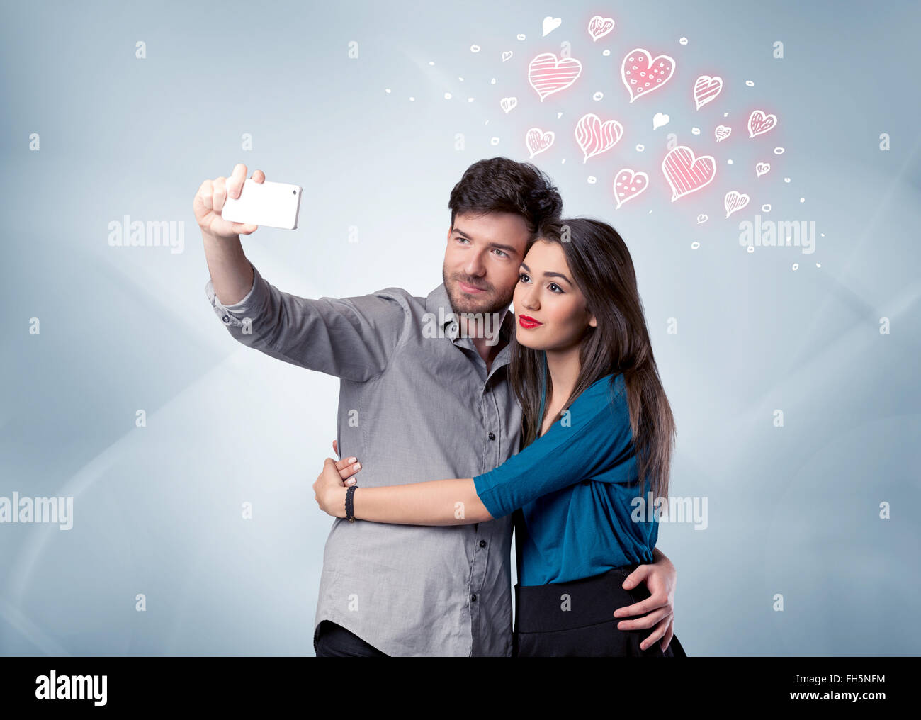 Couple in love taking selfie with red heart Stock Photo - Alamy