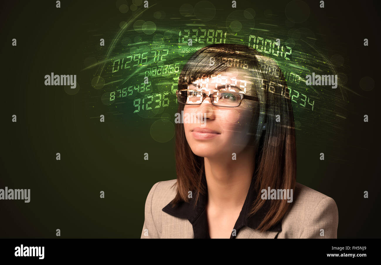 Business woman looking at high tech number calculations Stock Photo - Alamy