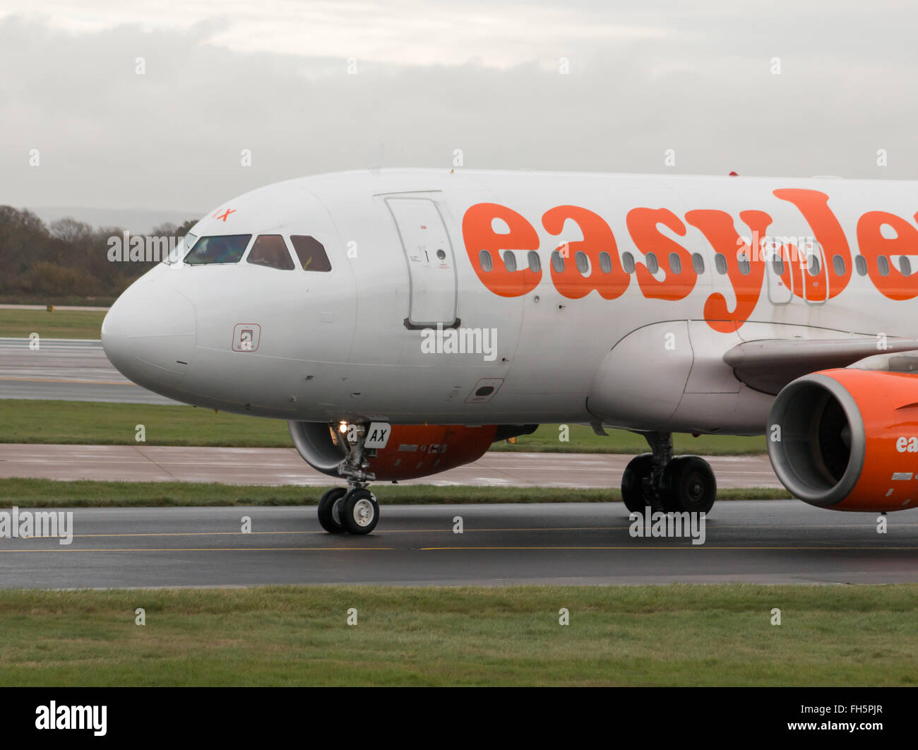easyJet Airbus A319 narrow-body passenger plane (G-EZAX) takiing on Manchester International Airport tarmac. Stock Photo