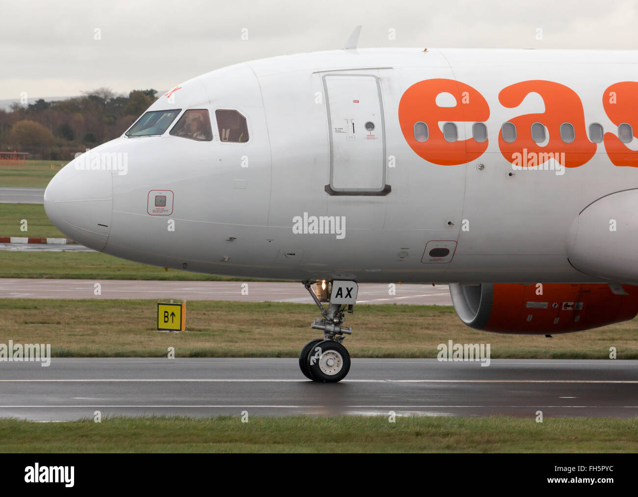 easyJet Airbus A319 narrow-body passenger plane (G-EZAX) takiing on Manchester International Airport tarmac. Stock Photo