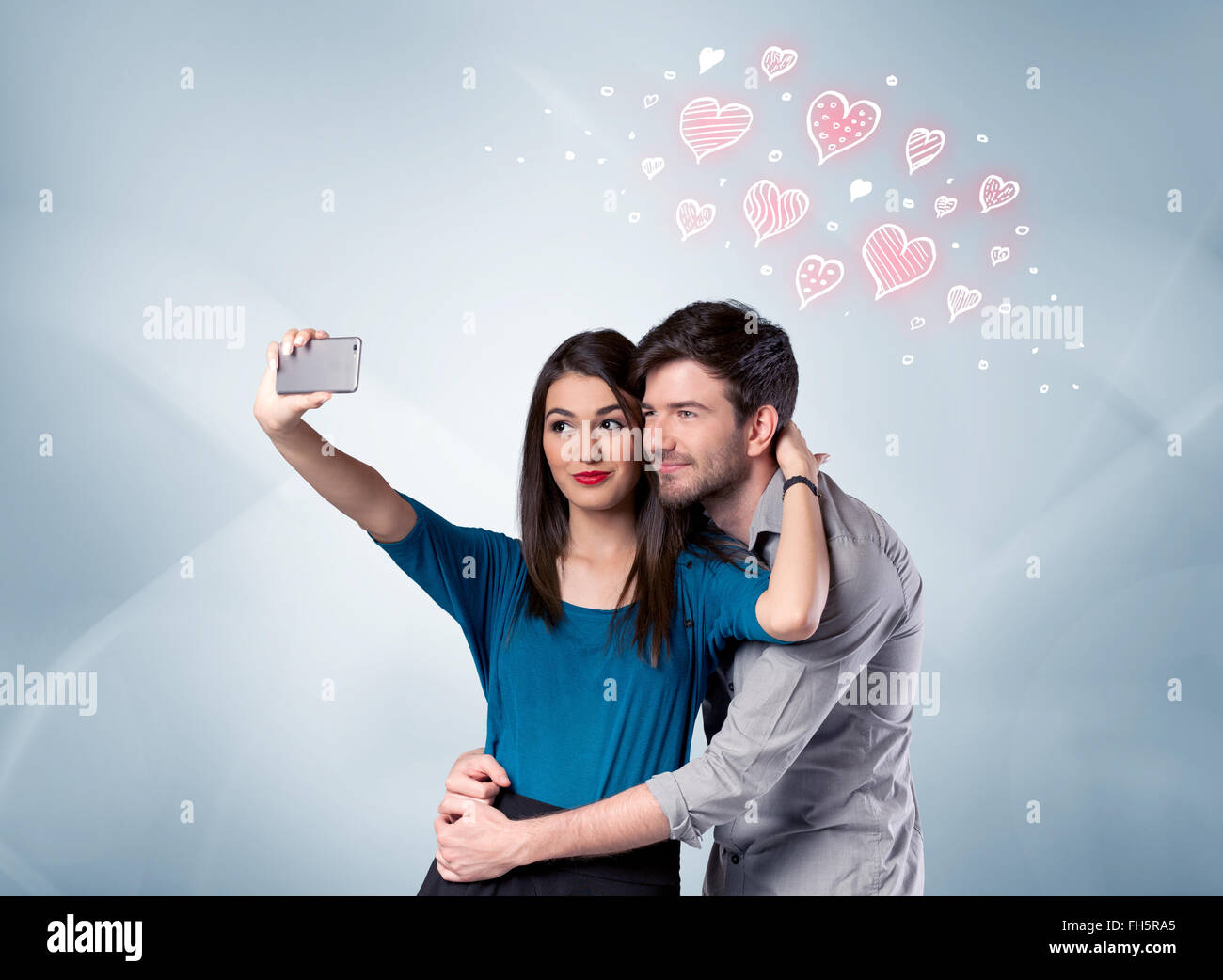 Couple in love taking selfie with red heart Stock Photo - Alamy