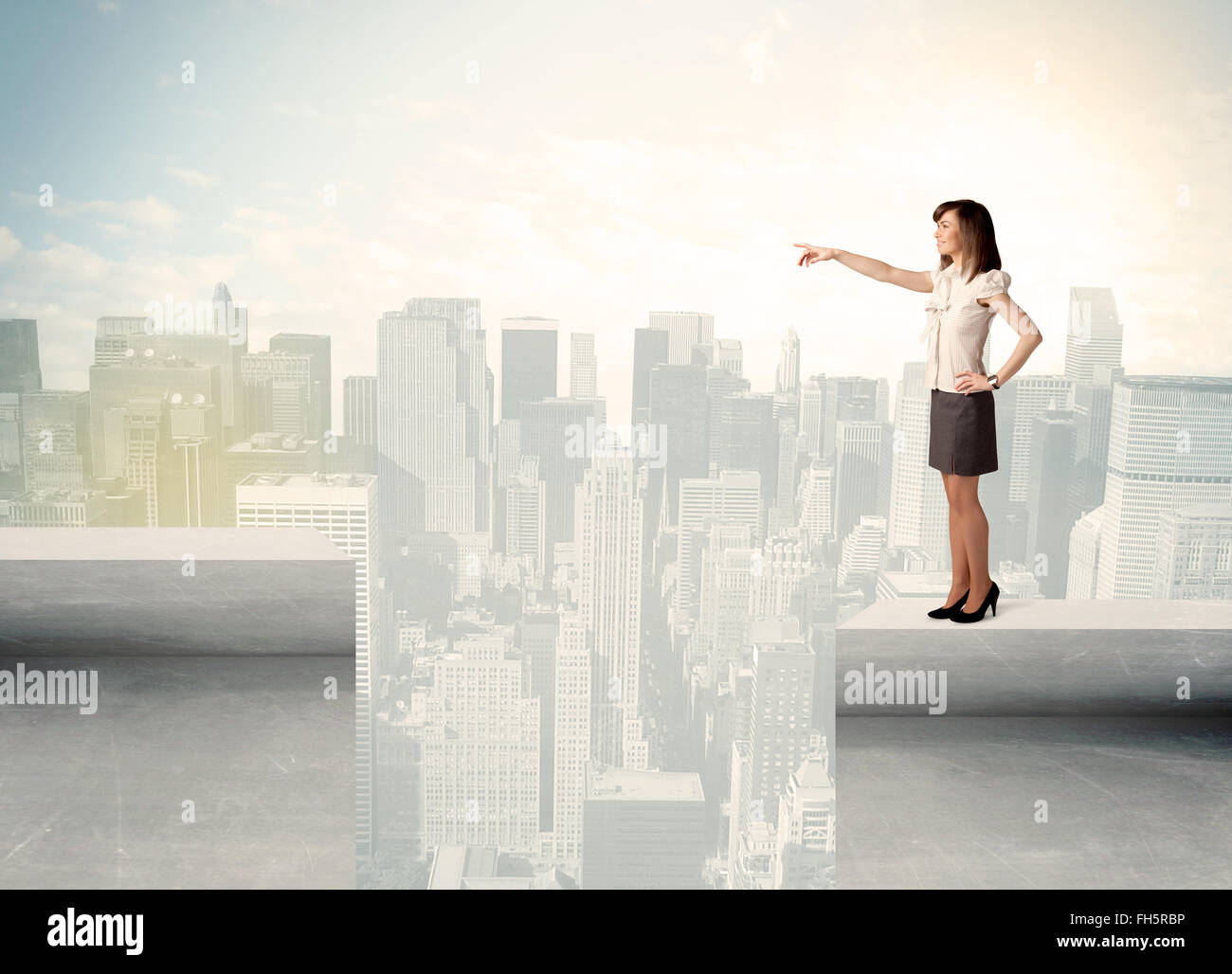Businesswoman standing on the edge of rooftop Stock Photo