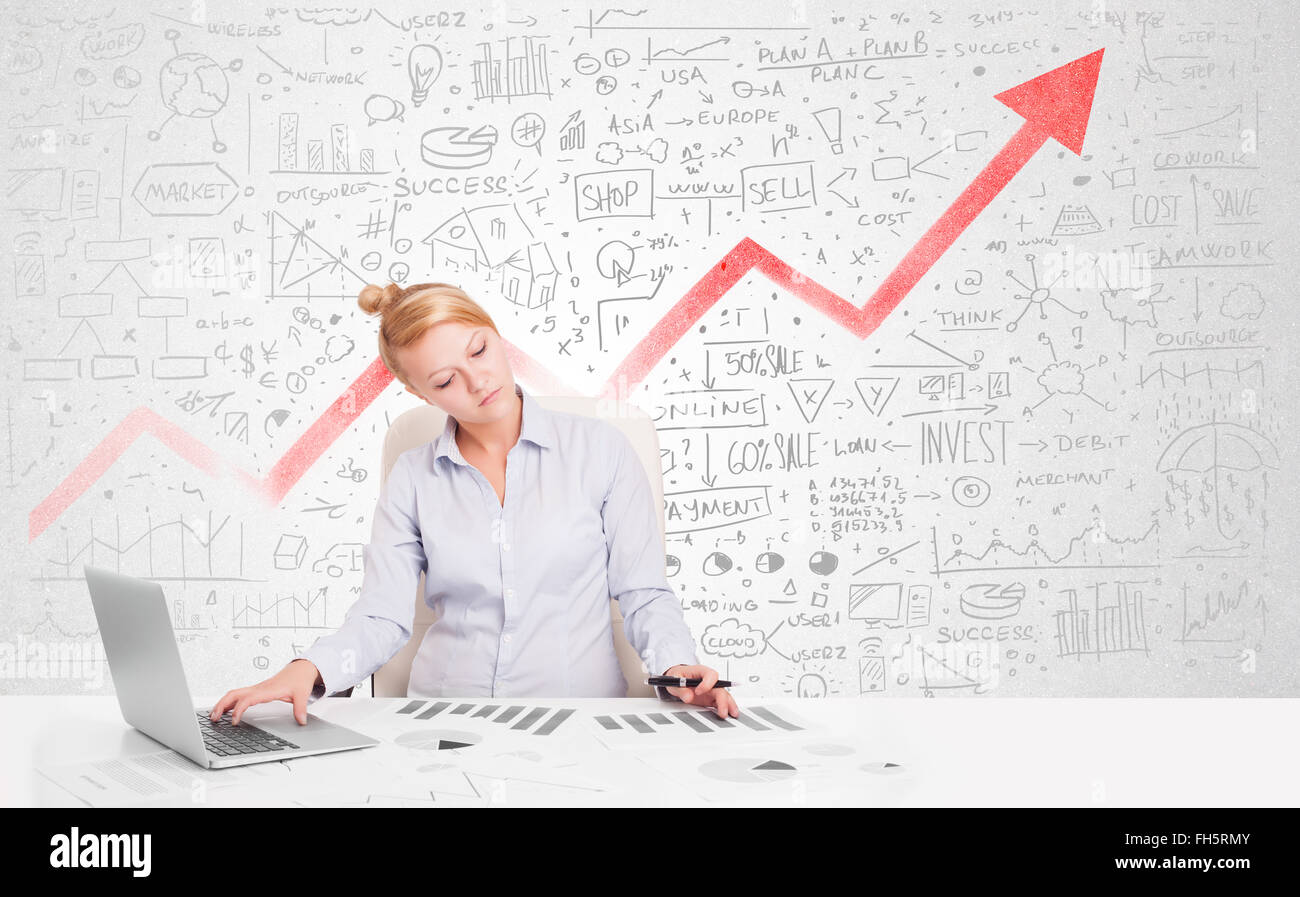 Business woman sitting at table with market diagrams Stock Photo - Alamy