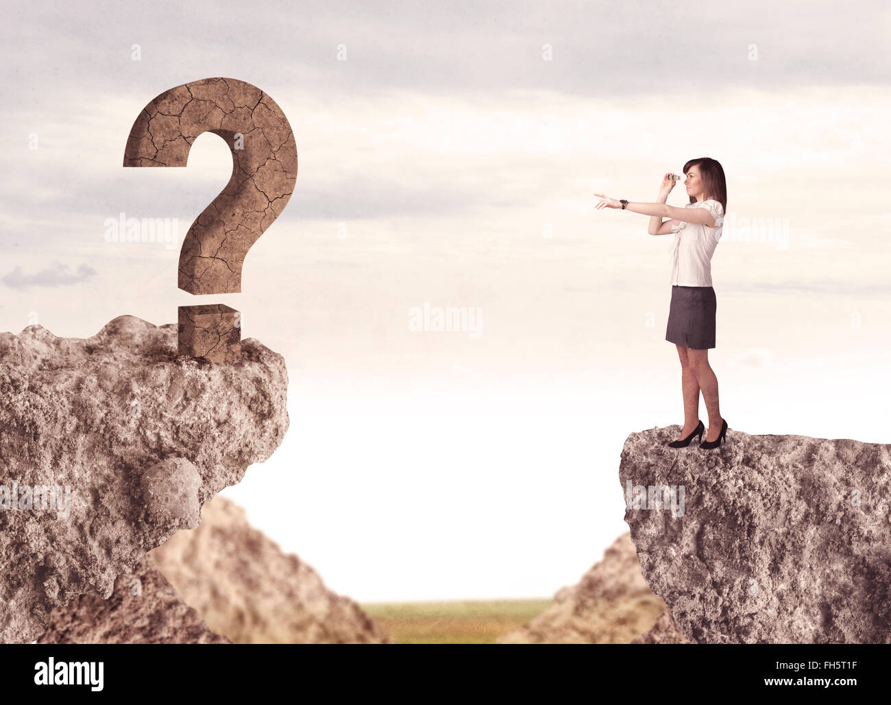 Businesswoman on rock mountain with a question mark Stock Photo