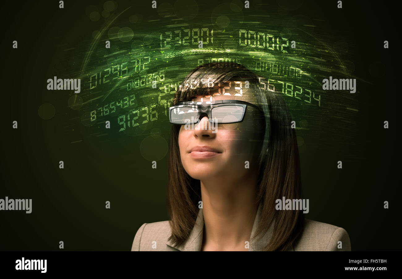Business woman looking at high tech number calculations Stock Photo - Alamy