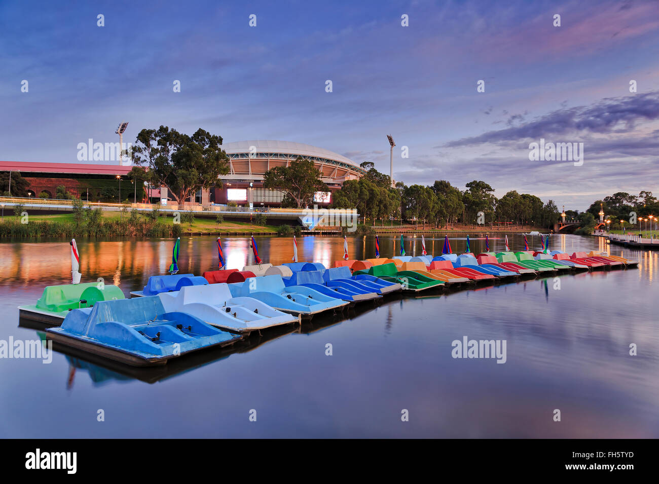 paddle boats on calm water of Torrens river in Adelaide at sunrise. Stock Photo