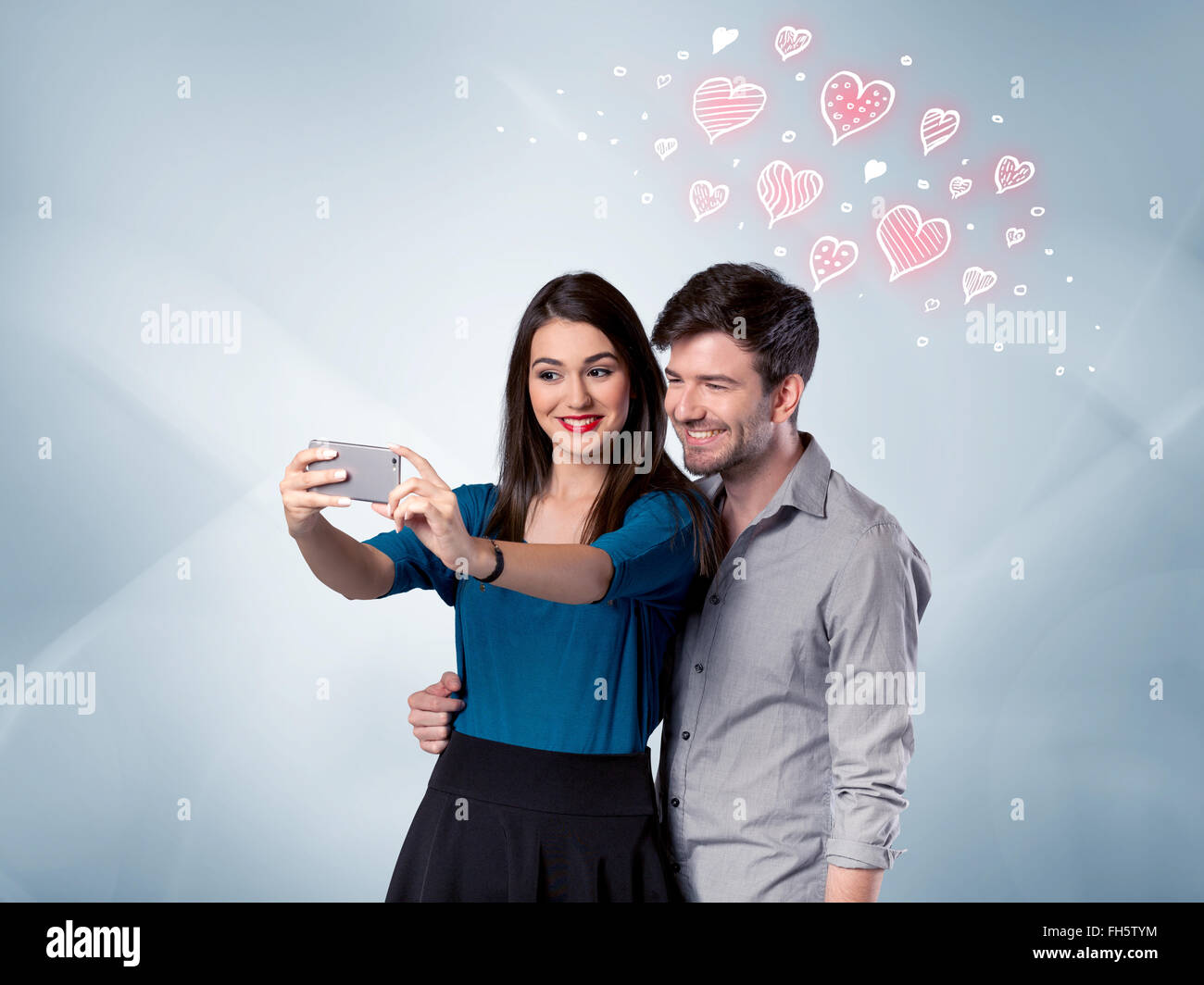 Couple in love taking selfie with red heart Stock Photo - Alamy