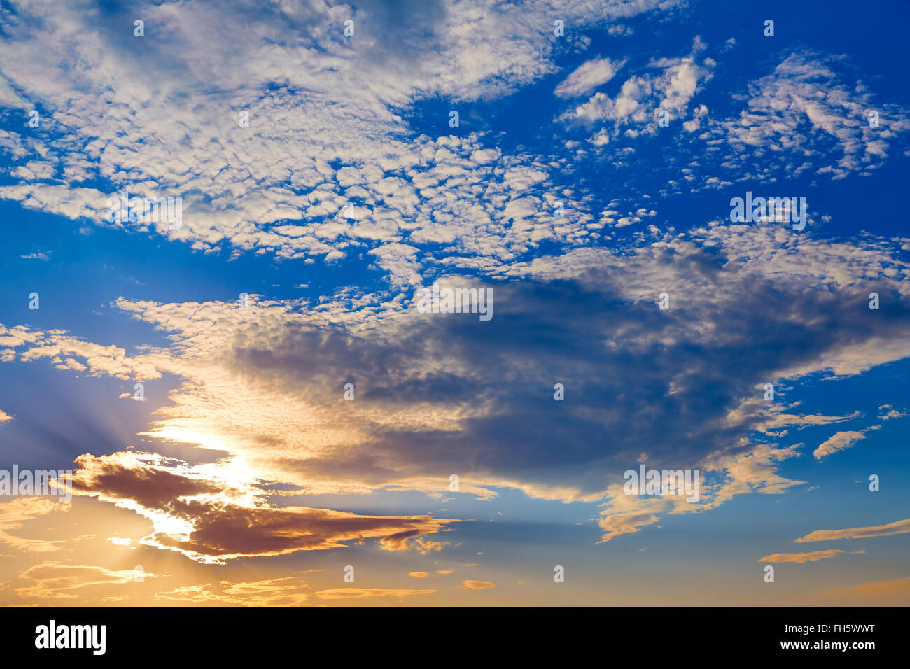 Sunset sky with golden and blue clouds in Mediterranean Stock Photo - Alamy