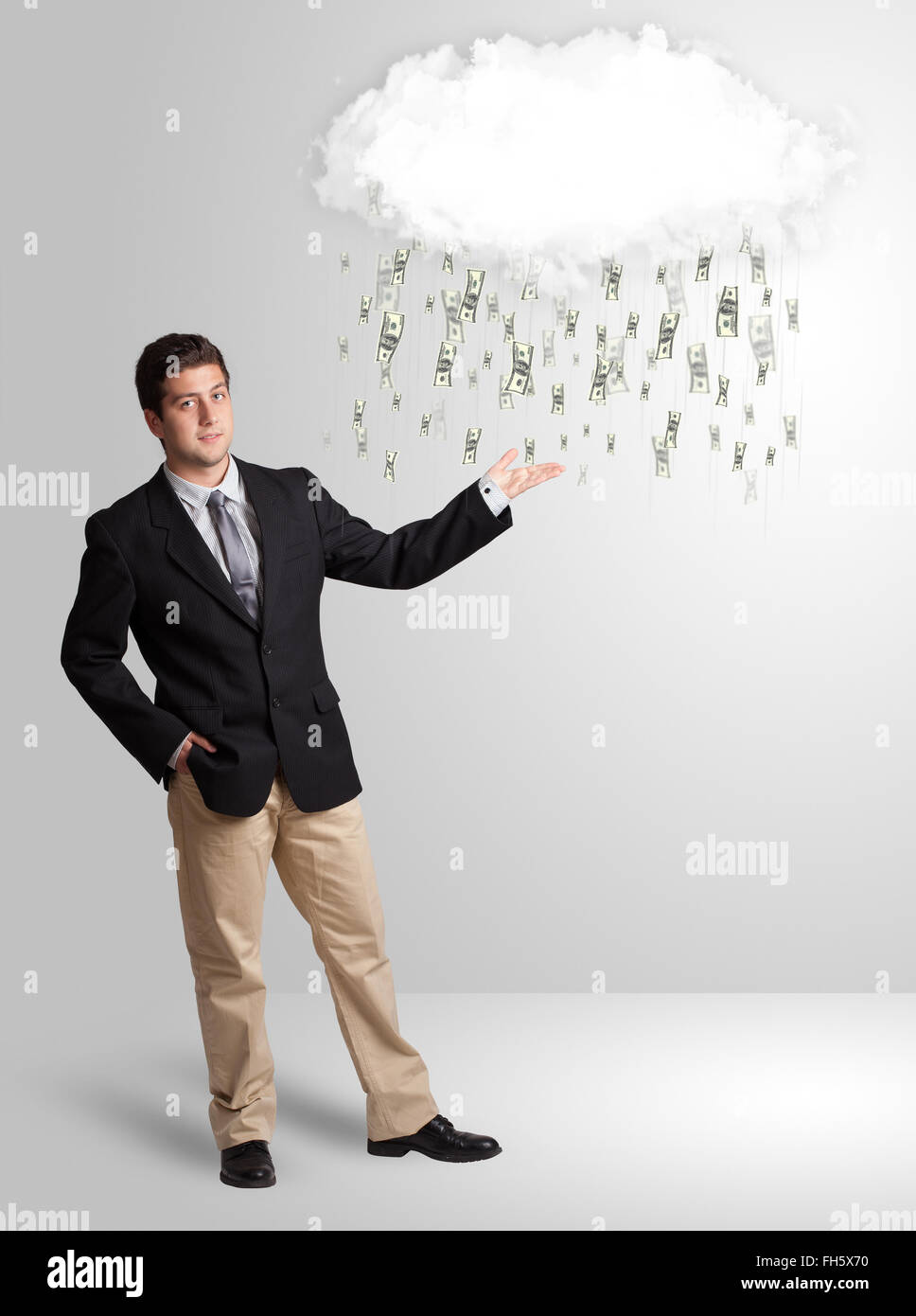Man with cloud and money rain concept Stock Photo - Alamy