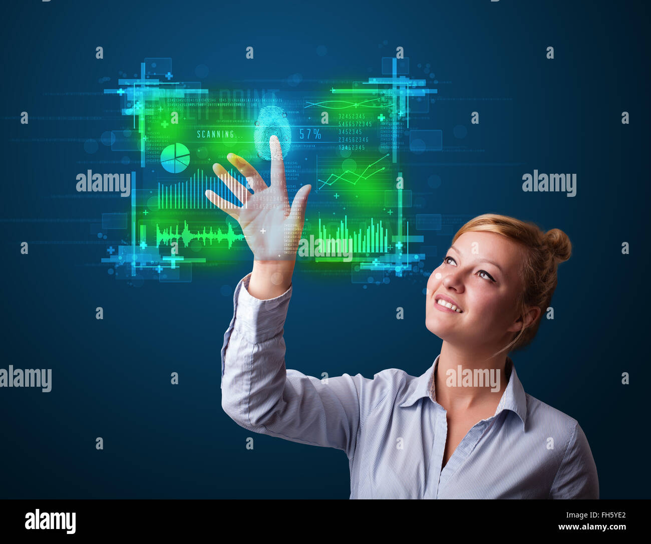 Young businesswoman pressing modern technology panel with finger print reader Stock Photo